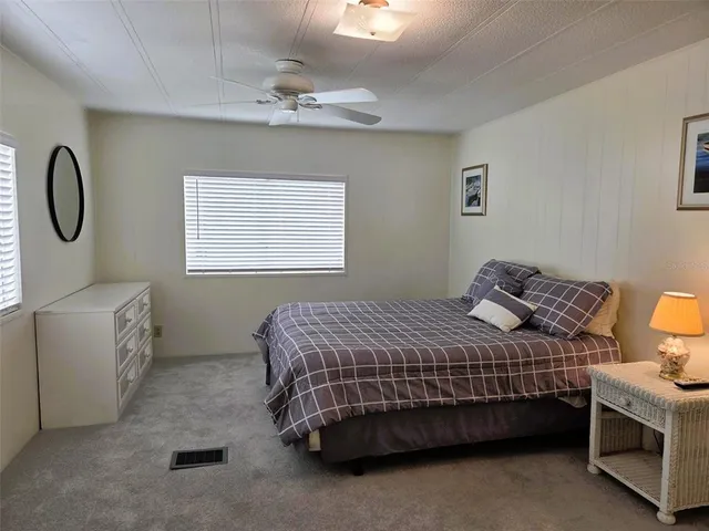 a living room with furniture and a dining table with wooden floor