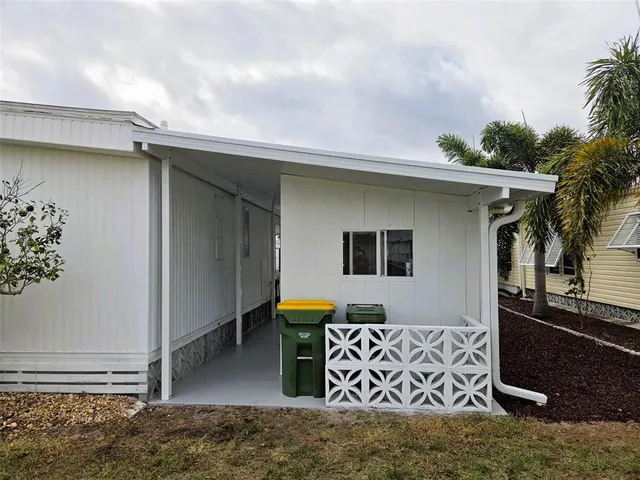 a kitchen with a refrigerator and a stove top oven
