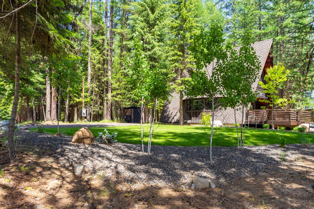 501 Gamble Road McCall, ID 83638 - Photo 20 of 28 Beautiful landscaping, With perennials, aspens and a mix of firs and pines, the sprinkler system keeps the lawn and landscaping in great condition.