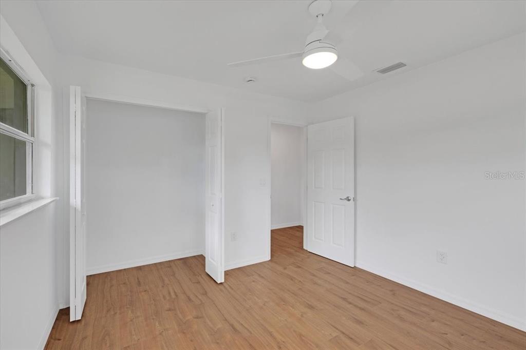 2206 Mark Avenue Punta Gorda, FL 33950 - Photo 18 of 22 a view of an empty room with wooden floor and a window