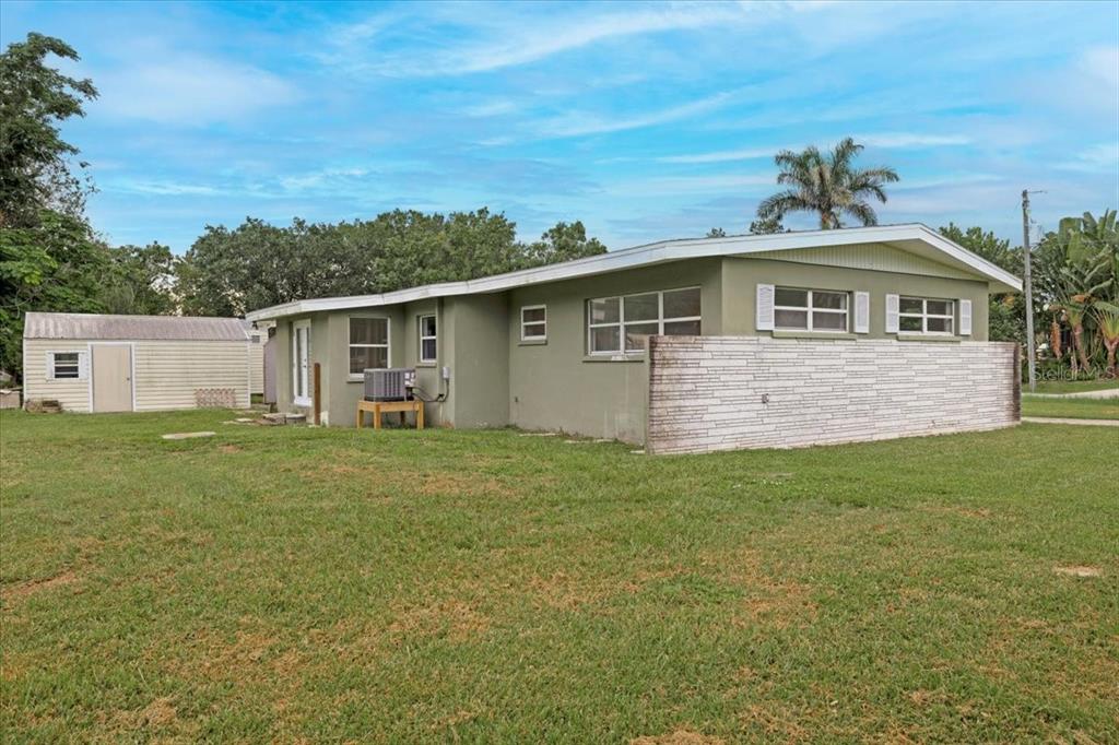 2206 Mark Avenue Punta Gorda, FL 33950 - Photo 20 of 22 a front view of house with yard and trees in the background