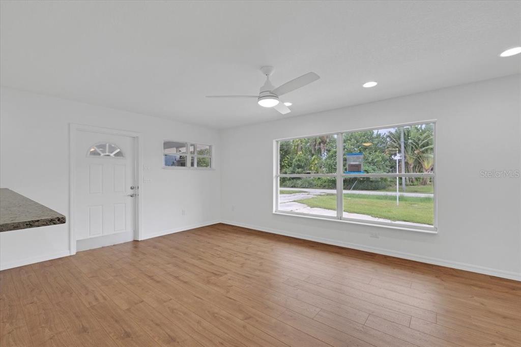 2206 Mark Avenue Punta Gorda, FL 33950 - Photo 4 of 22 an empty room with wooden floor and windows