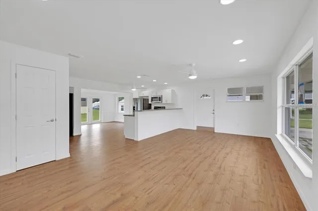 a view of a kitchen with wooden floor and a kitchen