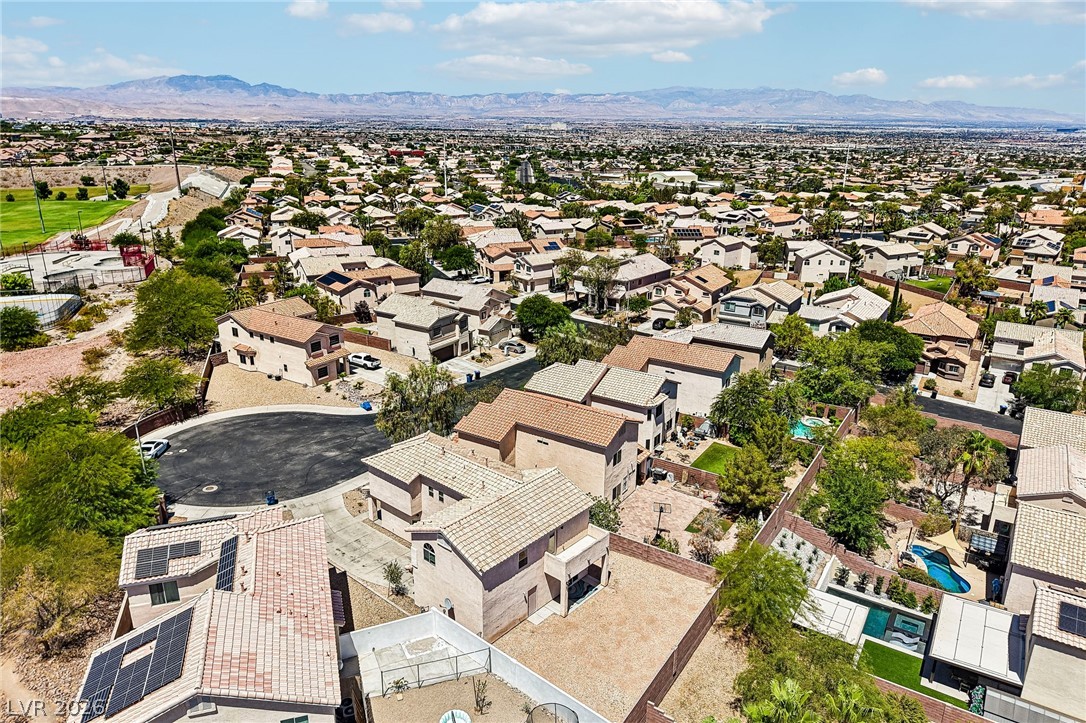 1176 Butternut Ranch Court Henderson, NV 89052 - Photo 53 of 60 An aerial perspective reveals a vibrant neighborhood with mountain views and green spaces.