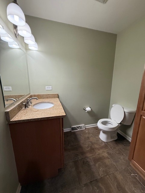 969 Dearborn Circle Carol Stream, IL 60188 - Photo 26 of 46 a bathroom with a sink vanity mirror and toilet