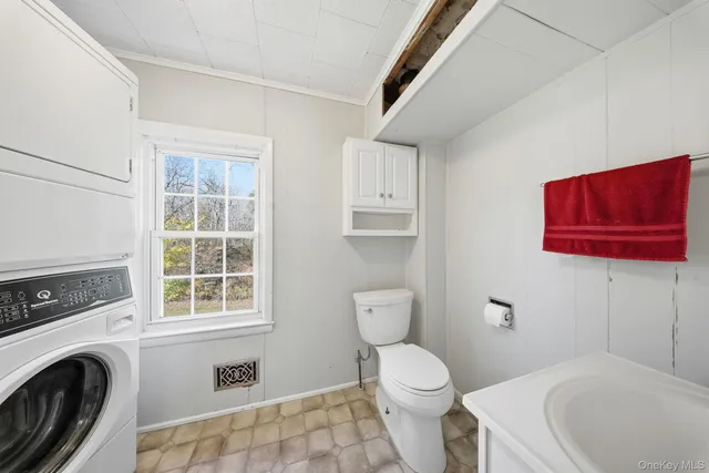 a bathroom with a sink a washer and dryer