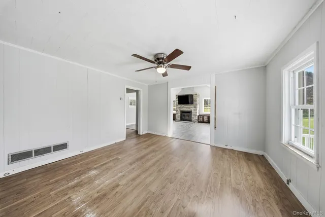 wooden floor in an empty room with a window