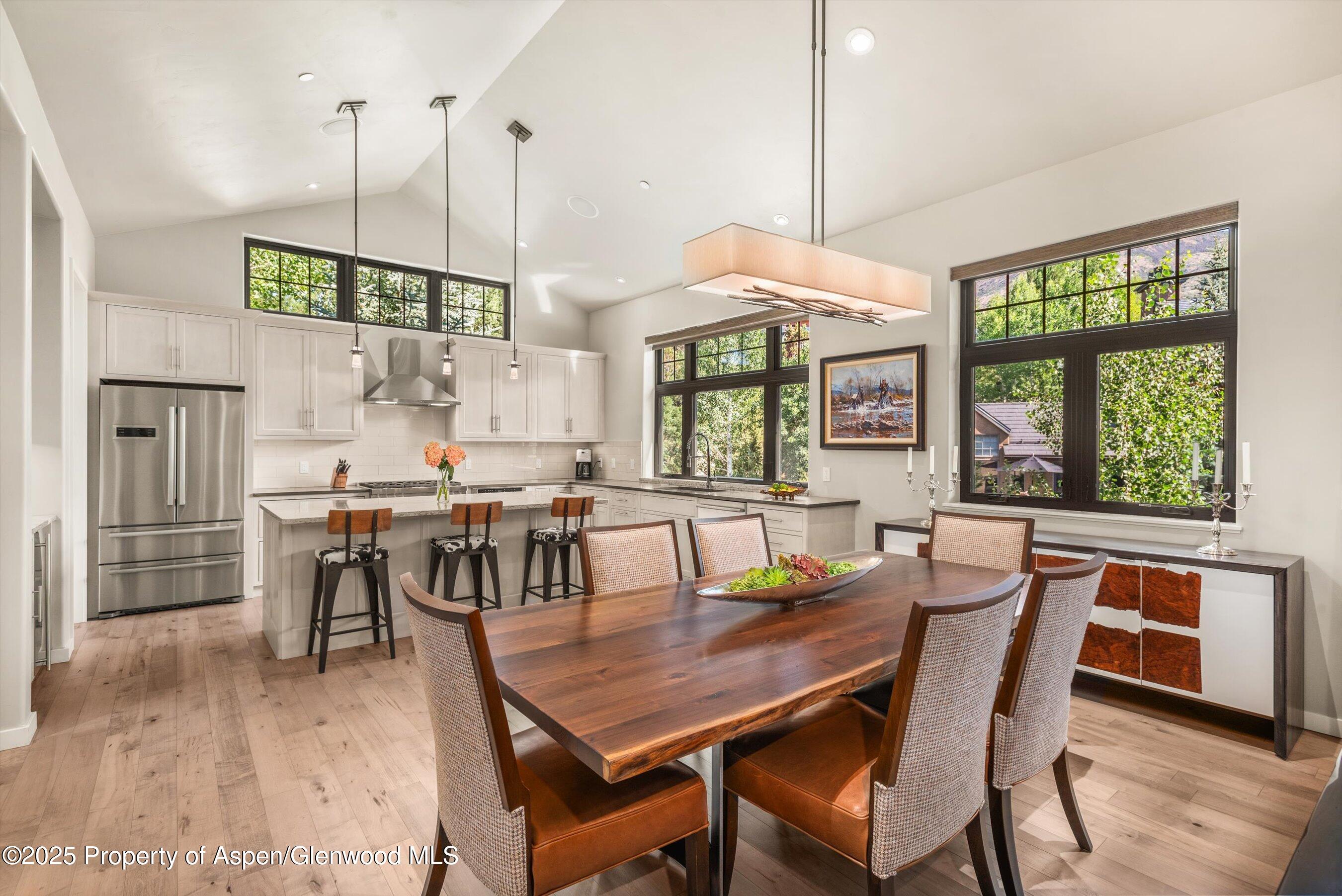 102 Wild Spring Lane Basalt, CO 81621 - Photo 23 of 51 a dining room with furniture a chandelier and wooden floor