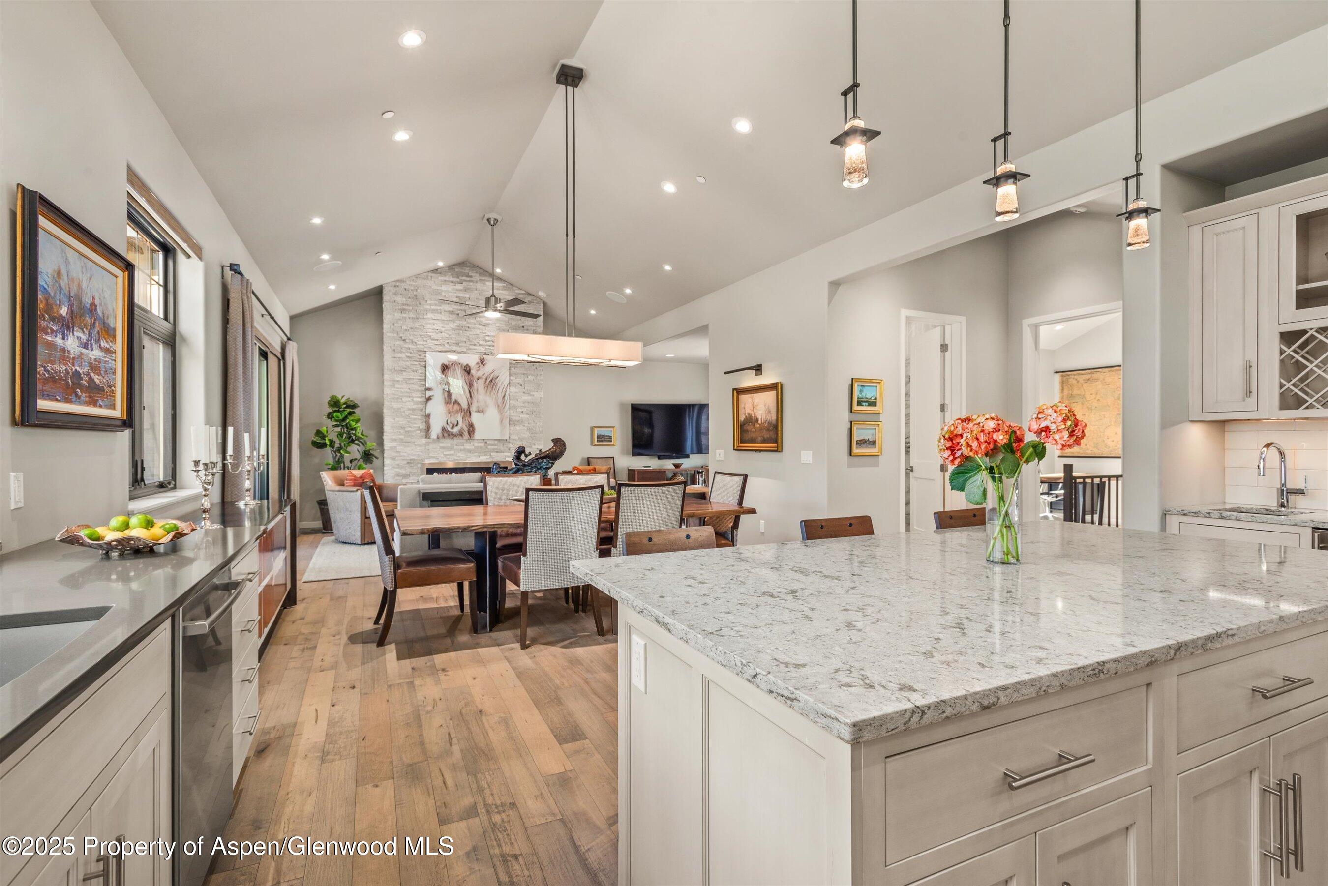 102 Wild Spring Lane Basalt, CO 81621 - Photo 27 of 51 a kitchen with granite countertop kitchen island stainless steel appliances a table and chairs