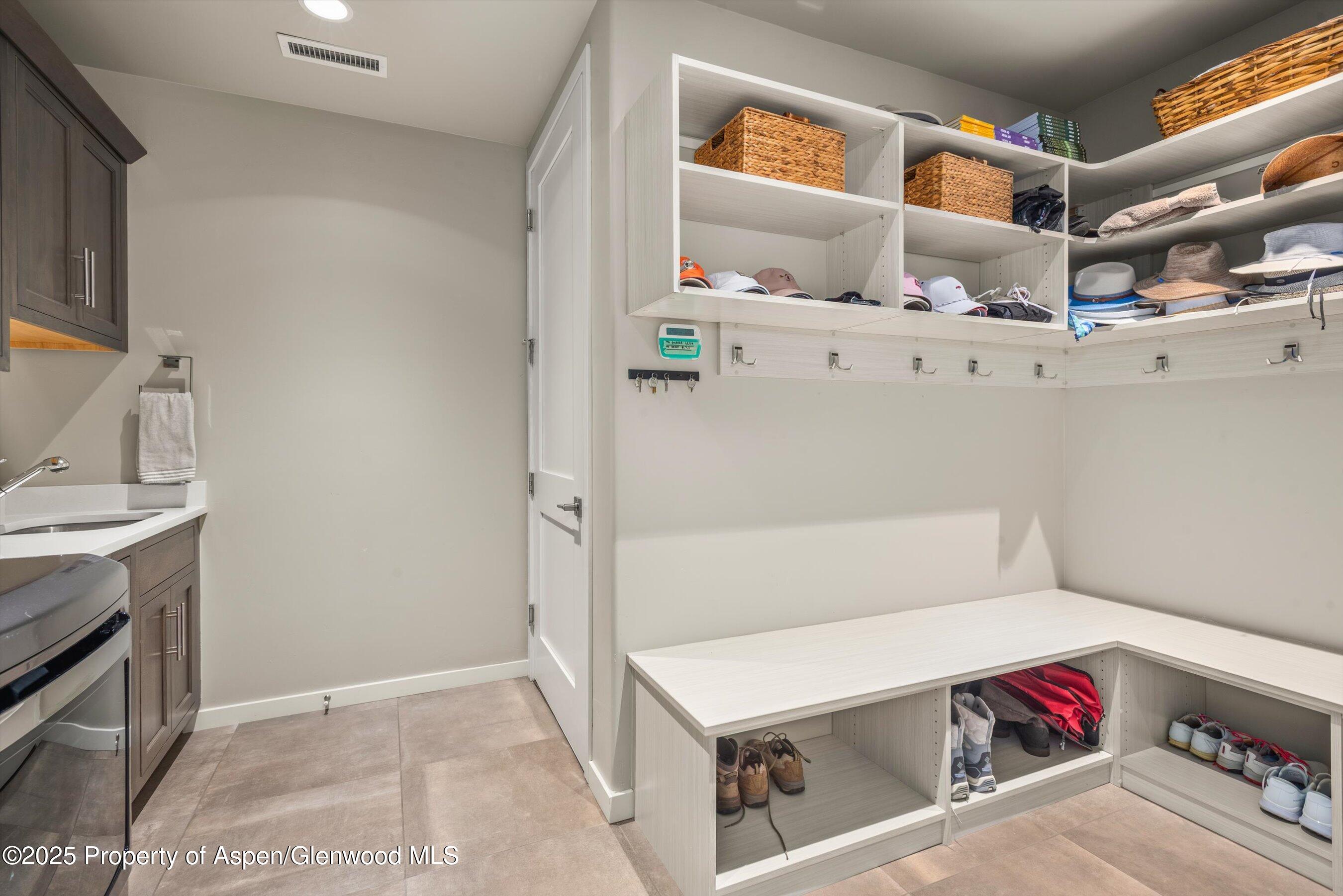 102 Wild Spring Lane Basalt, CO 81621 - Photo 38 of 51 a utility room with cabinets washer and dryer