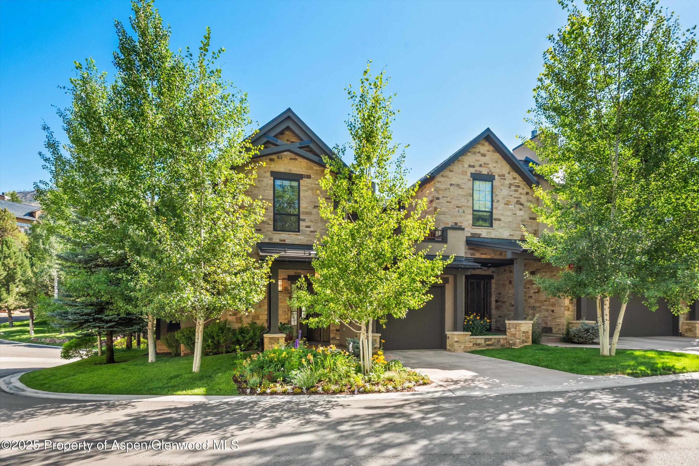 102 Wild Spring Lane Basalt, CO 81621 - Photo 45 of 51 a front view of a house with a yard and garage