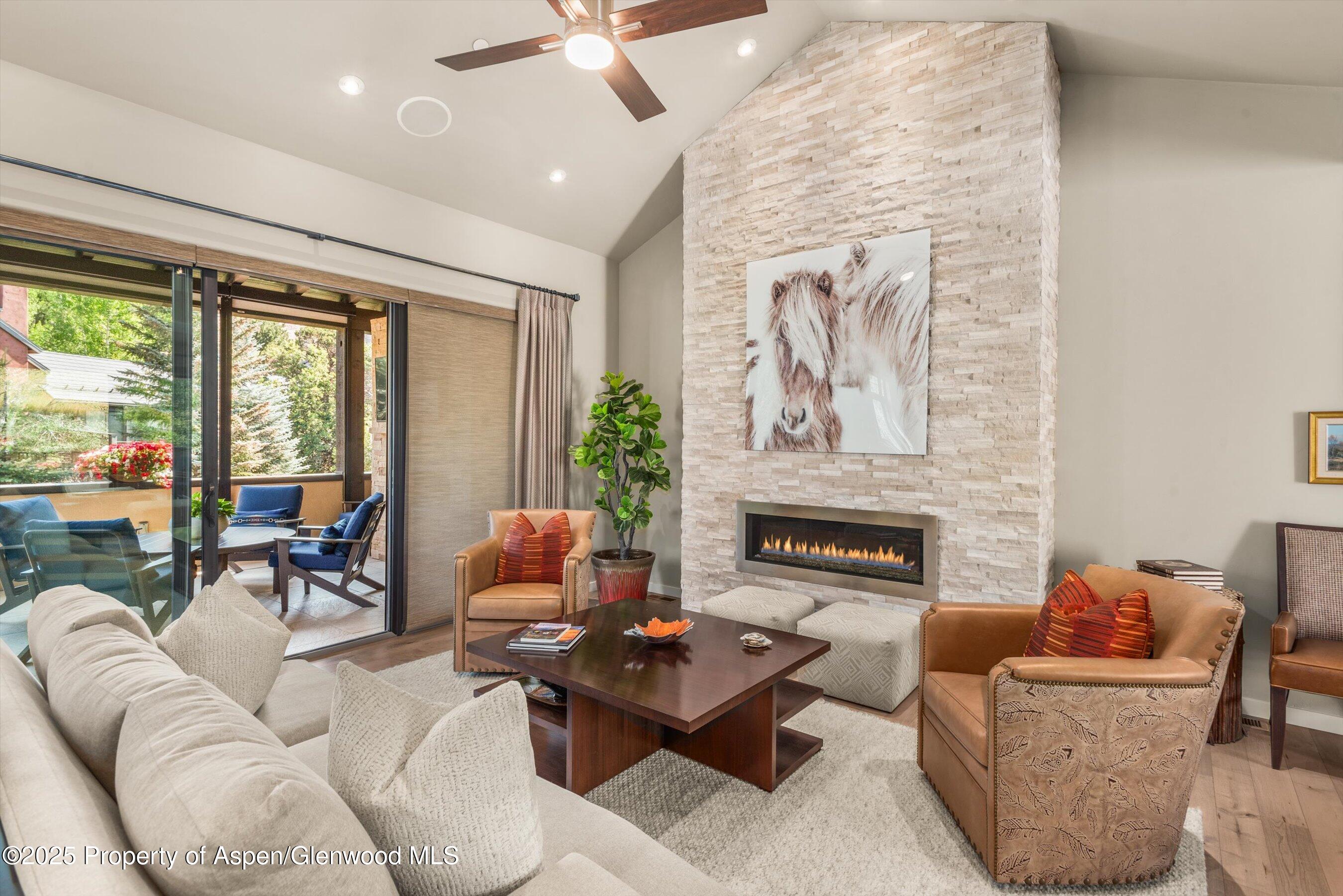 102 Wild Spring Lane Basalt, CO 81621 - Photo 7 of 51 a living room with furniture fireplace and large windows