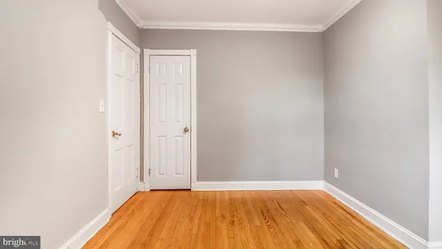 a view of a room with wooden floor and a window