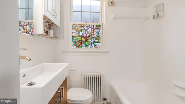 a bathroom with a sink a toilet and a bathtub
