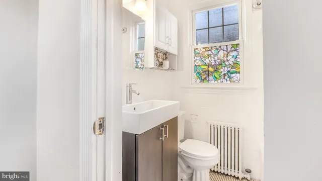 a street sign on a brick wall next to a road