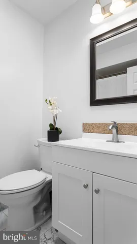 a bathroom with a toilet a sink and mirror