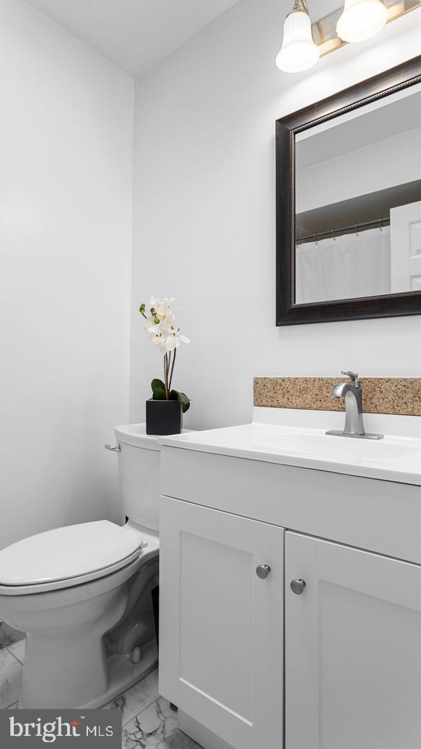 3045 Comly Road Philadelphia, PA 19154 - Photo 16 of 29 a bathroom with a toilet a sink and mirror