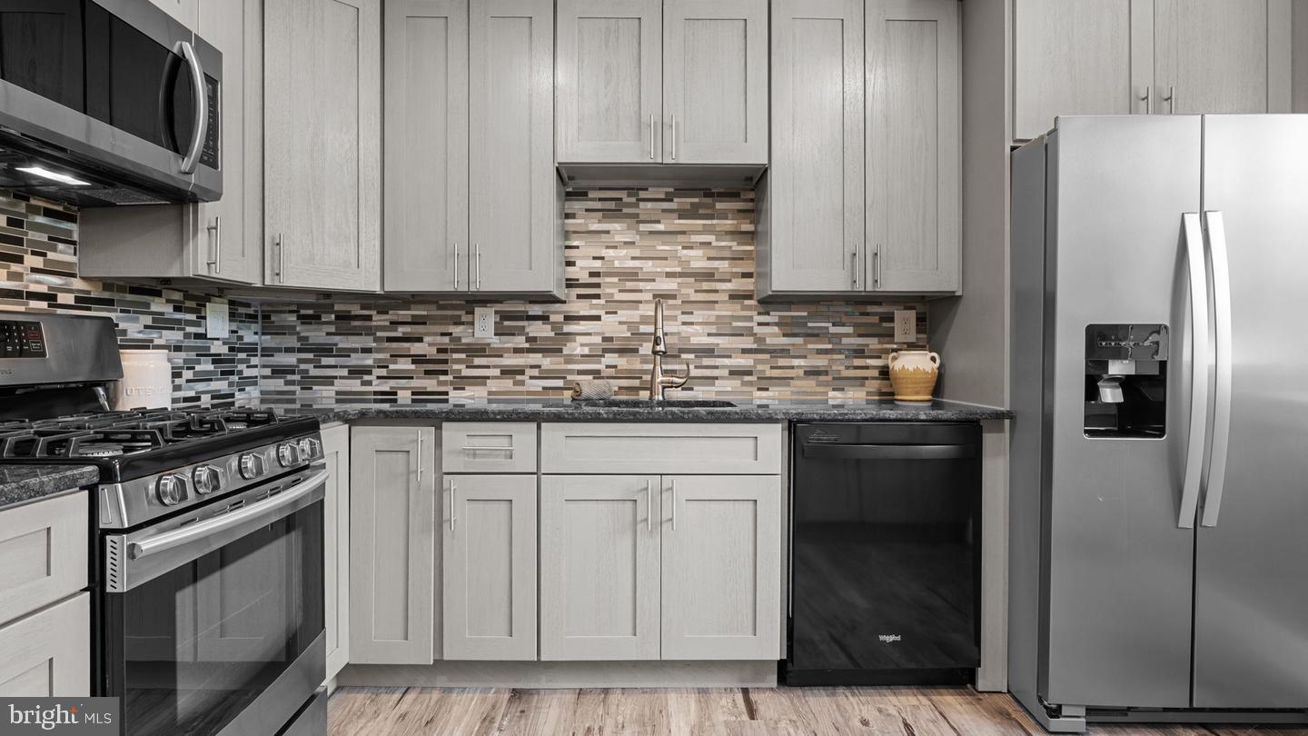 3045 Comly Road Philadelphia, PA 19154 - Photo 5 of 29 a kitchen with stainless steel appliances granite countertop a refrigerator stove and cabinets