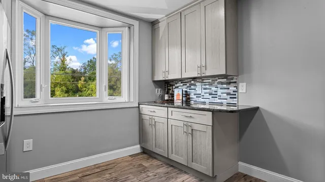 a kitchen with granite countertop a sink and a window