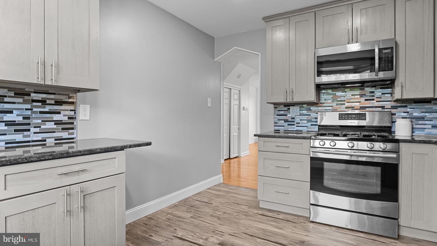 3045 Comly Road Philadelphia, PA 19154 - Photo 8 of 29 a kitchen with stainless steel appliances granite countertop a stove microwave and sink
