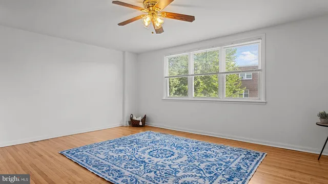 a view of a room with wooden floor and chandelier