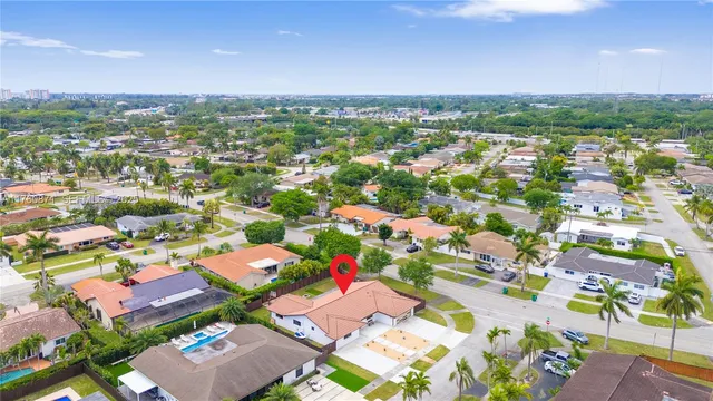 a kitchen with stainless steel appliances granite countertop a refrigerator a stove a kitchen island and chairs