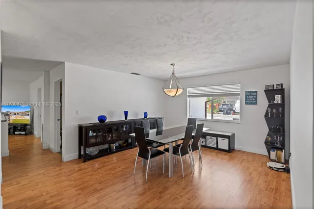 a view of a dining room with furniture and chandelier