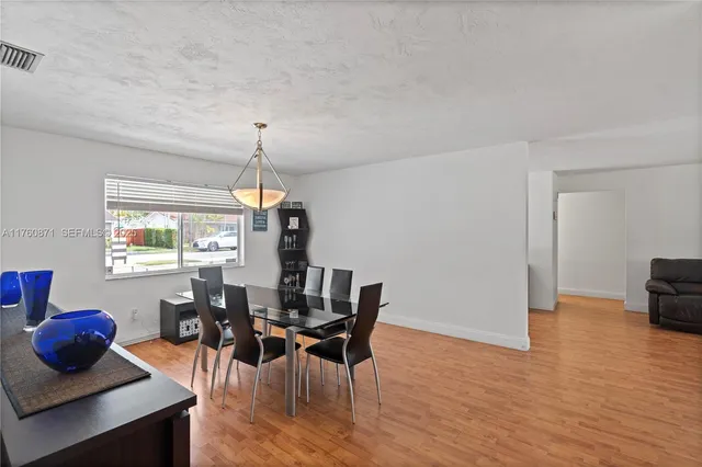 a dining room with furniture and window