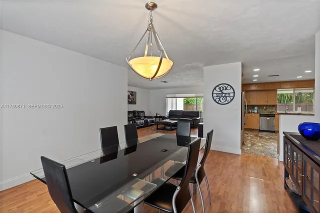a living room with furniture and a view of kitchen