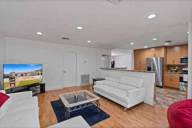 a spacious bedroom with a bed and a dresser