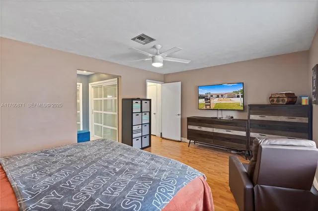 a bedroom with a bed and wooden floor