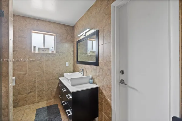 a utility room with faucet washer and dryer