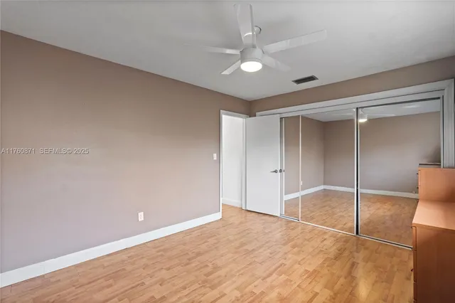 a view of a backyard with wooden fence