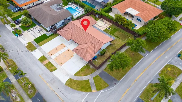 an aerial view of residential houses with outdoor space and street view