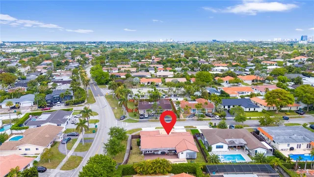 an aerial view of residential building with outdoor space and parking