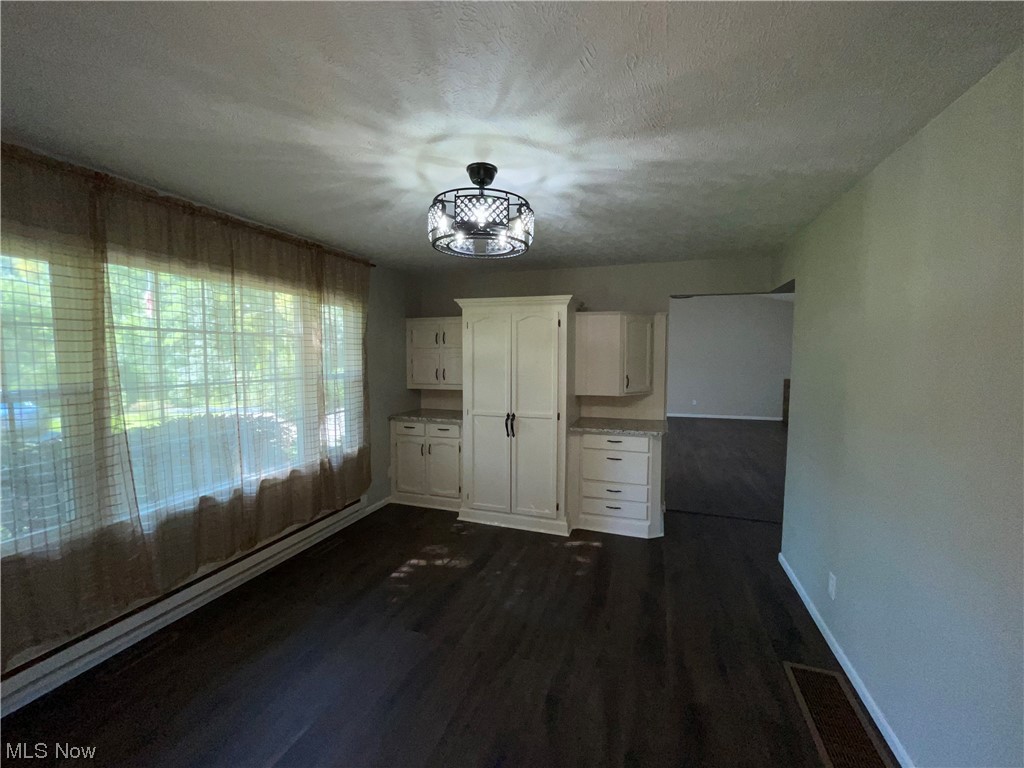 7114 Risden Road Vermilion, OH 44089 - Photo 16 of 35 Unfurnished room featuring dark hardwood floors