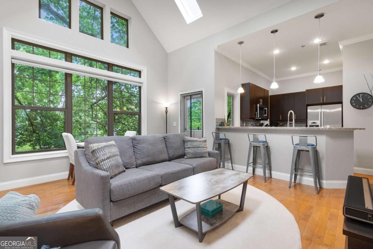 1903 Anjaco Road Northwest, Unit 5 Atlanta, GA 30309 - Photo 1 of 1 a living room with furniture and a large window
