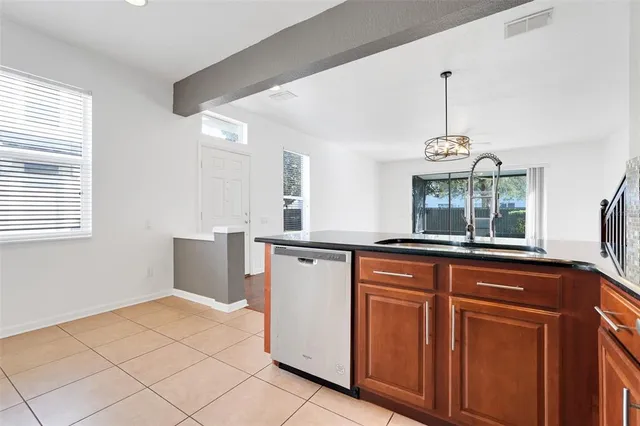 a kitchen with granite countertop white cabinets and window