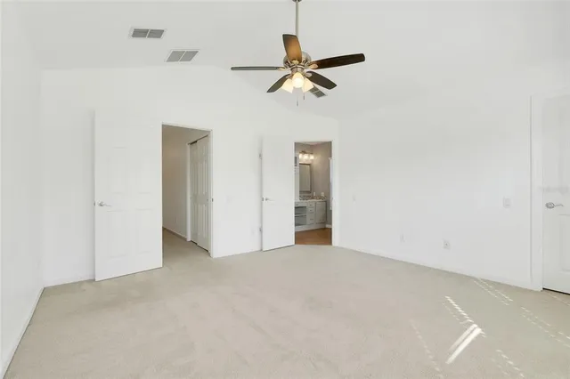 a view of a livingroom with a ceiling fan and entryway