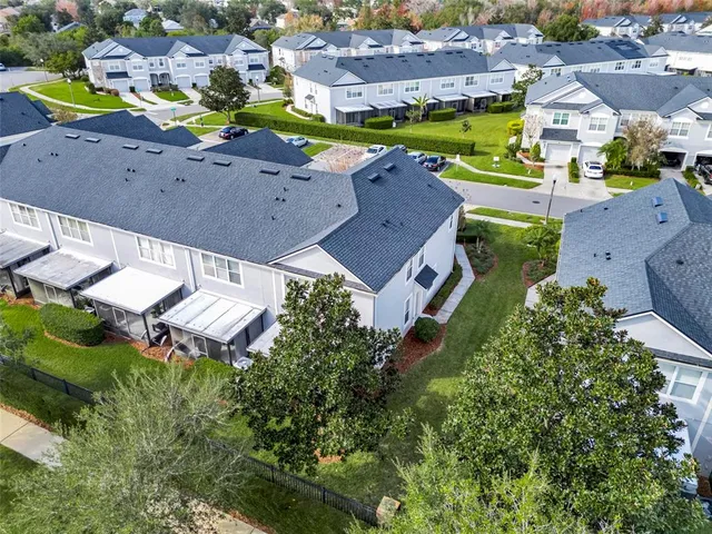 an aerial view of multiple houses with yard