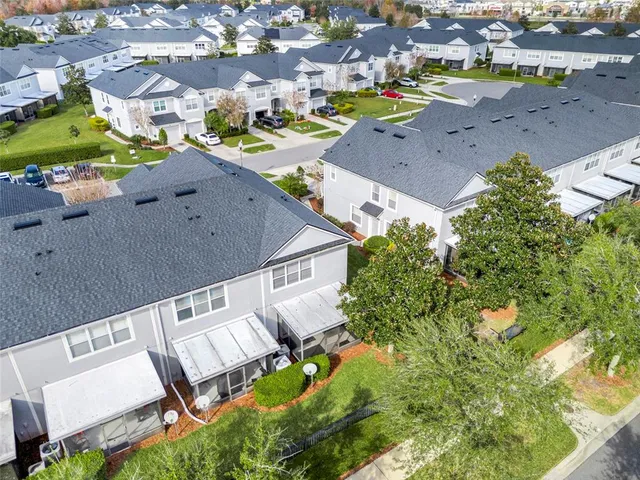 an aerial view of a house with a yard