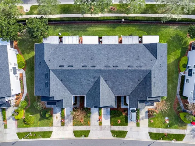 an aerial view of a house with a garden and lake view