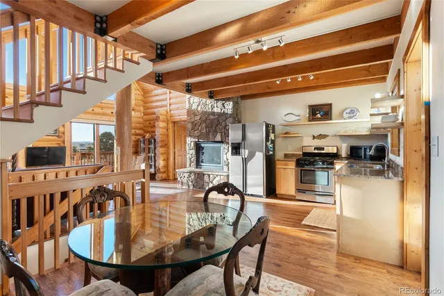 a kitchen with stainless steel appliances granite countertop a stove top oven a sink and a refrigerator