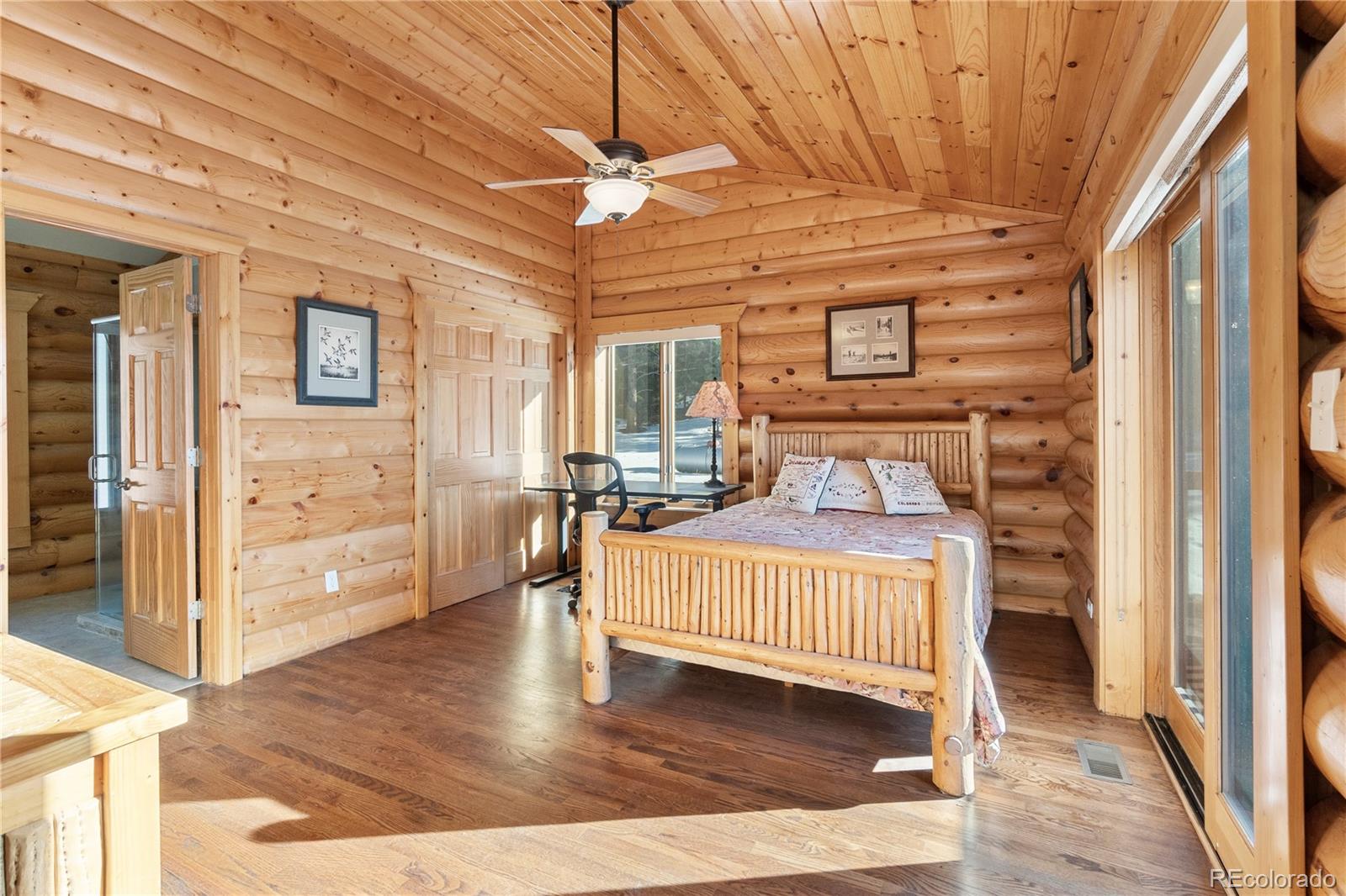 17245 Elbert Road Peyton, CO 80831 - Photo 20 of 45 a bedroom with a bed and wooden floor