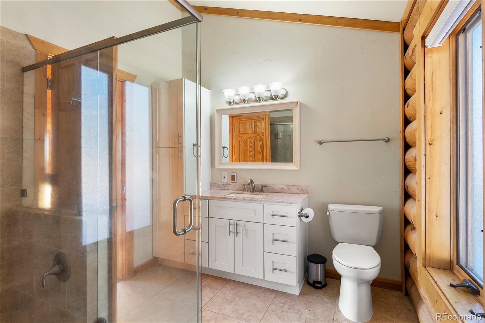 17245 Elbert Road Peyton, CO 80831 - Photo 21 of 45 a bathroom with a granite countertop toilet sink and a shower