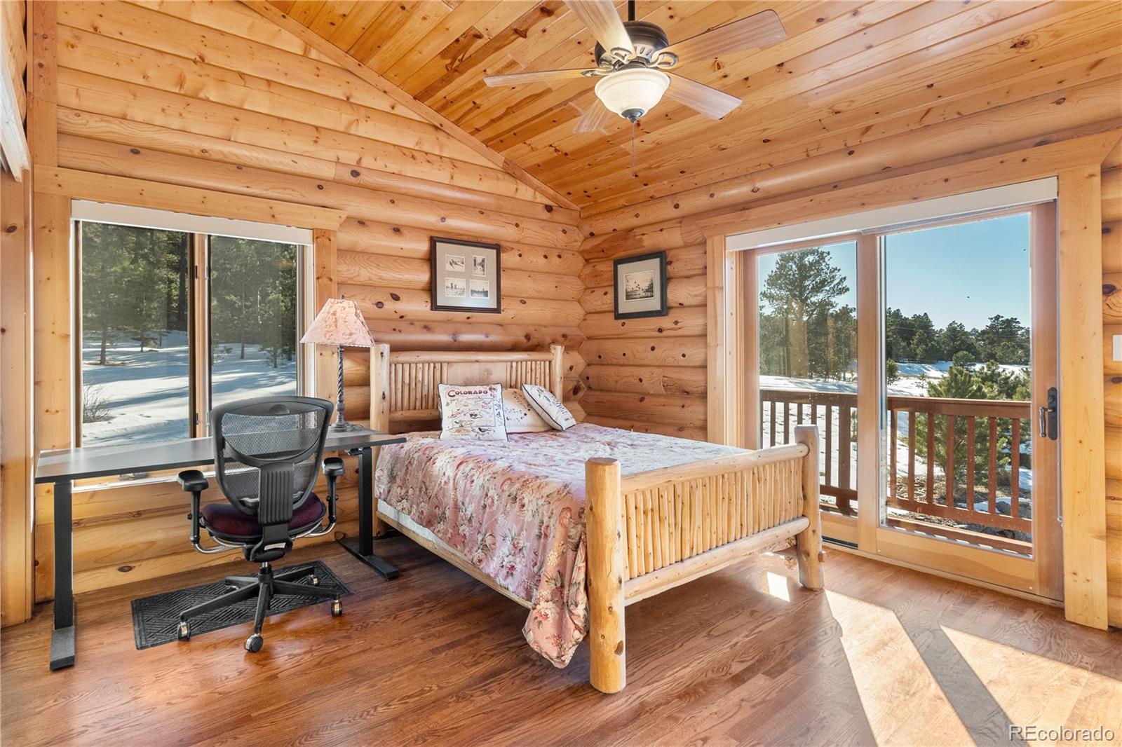 17245 Elbert Road Peyton, CO 80831 - Photo 22 of 45 a bedroom with a bed and wooden floor