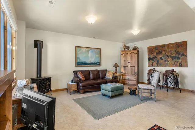 a living room with furniture gym equipment and a rug