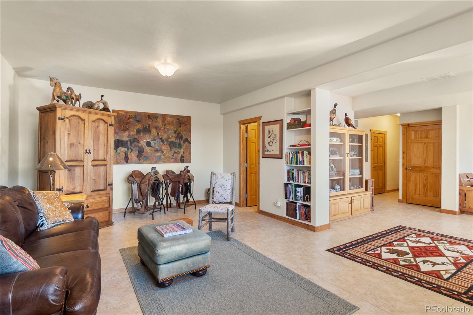 17245 Elbert Road Peyton, CO 80831 - Photo 30 of 45 a living room with furniture gym equipment and a rug