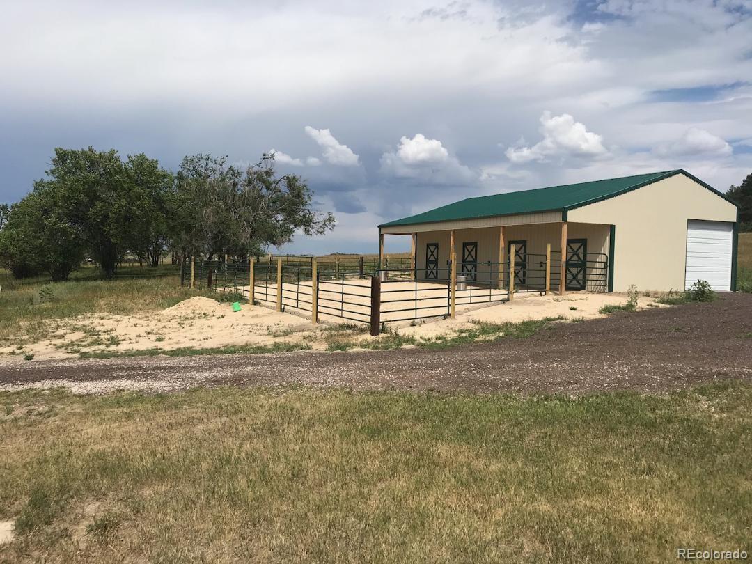 17245 Elbert Road Peyton, CO 80831 - Photo 35 of 45 a view of a house with a backyard and a tree