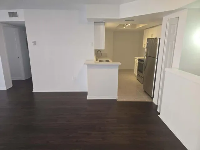 a view of a kitchen from the hallway